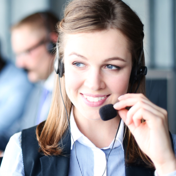 A friendly person working in a call center speaking to someone on the phone.
